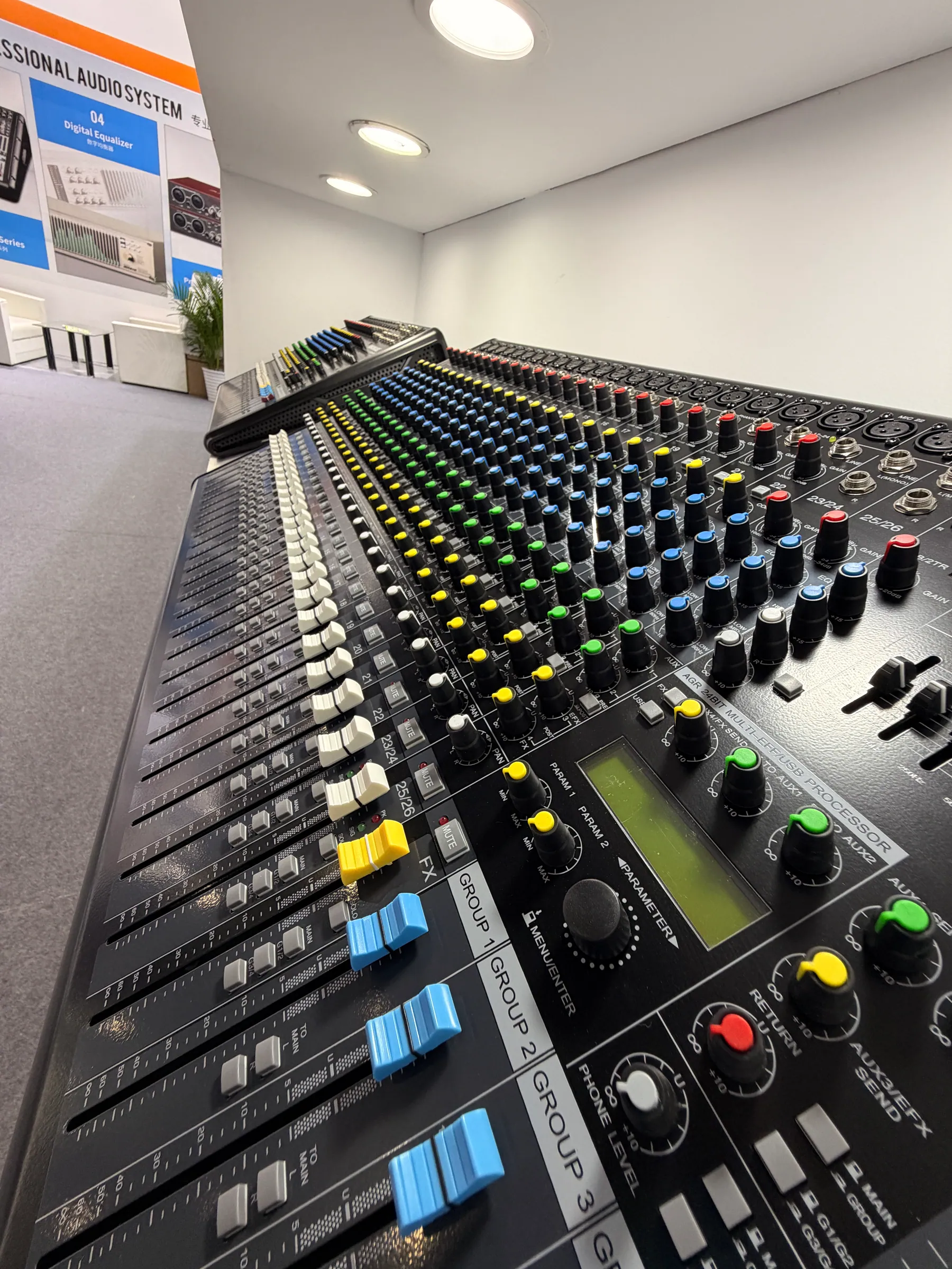 Close-up of a professional analog mixing console at the MICKLE AUDIO booth
